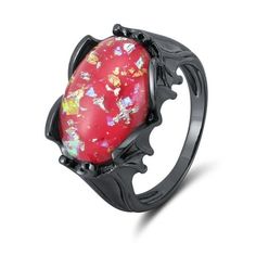 Step into a world of mystique and elegance with the Dragoneye Fantasy Ring from the Ginger Lyne Collection. This intricately designed piece combines striking craftsmanship with a bold, otherworldly aesthetic. At its center lies a stunning 17mm x 12mm Acro stone, available in Black, Purple, or Red. Enhanced with shimmering gold and silver foil flakes, the stone captures light beautifully, giving it an ethereal, dome-like effect. Crafted from high-quality sterling silver and plated with luxurious Elvish Ring, Elven Ring, Gothic Dragon, Intricate Rings, Gothic Engagement Ring, Fantasy Ring, Dragon Lover, Bat Wing, Dragon Wings