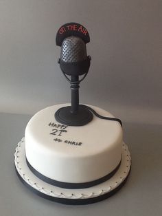 a white cake with a microphone on top that says, get the air happy 21st birthday