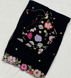 *Category: Women's Ethnic Wear *Fabric: Georgette *Color: Black with Multicolor Floral Embroidery *Blouse Size: 34-42 inches (adjustable) *Border: Floral Embroidery *Occasion: Suitable for festive occasions, weddings, and parties  This elegant  Georgette saree features a beautifully detailed floral embroidery border, making it perfect for any special occasion. The matching blouse piece can be tailored to fit sizes 34-44 inches. Enhance your wardrobe with this timeless piece. Disclaimer: There mi Bollywood Style Georgette Blouse With Embroidered Border, Bollywood-style Georgette Blouse With Embroidered Border, Wedding Georgette Blouse With Embroidered Border, Unstitched Multicolor Choli With Floral Embroidery, Festive Georgette Blouse With Embroidered Border, Semi-stitched Georgette Blouse With Embroidered Border, Transitional Multicolor Floral Embroidery Sets, Festive Embroidered Georgette Blouse, Designer Georgette Blouse With Embroidered Border