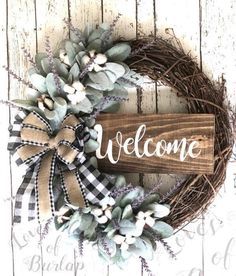 a welcome sign is hanging on a wreath