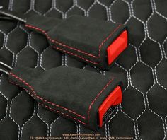 two black cases with red stitching on them