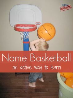 a young boy is playing with a basketball hoop and ball on the floor in front of him