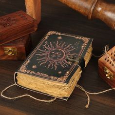 an open book sitting on top of a wooden table next to two boxes and a judge's hammer