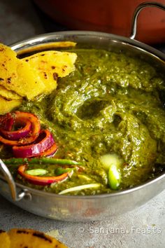 guacamole and tortilla chips are served in a silver bowl with salsa