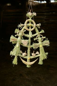 an ornament hanging from a rope with birds on it and pine cones in the shape of a christmas tree