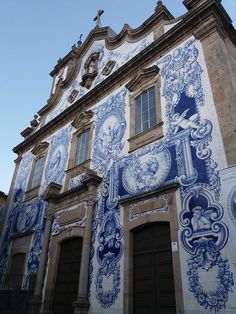 an old building with blue and white tiles on it