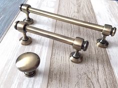 the handles and knobs on this door are made from brass metal, with wood grained flooring in the background