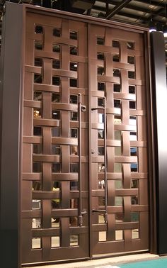 a large metal door with glass inserts on the sides and side panels that have squares in them