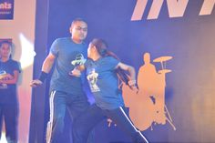 two people are dancing on stage at an event