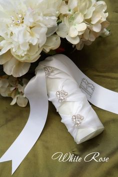 a bridal bouquet with white ribbon and flowers