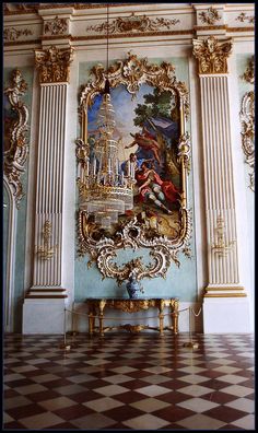 an ornately decorated room with paintings on the wall and flooring in front of it