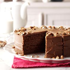 a chocolate cake on a plate with one slice cut out