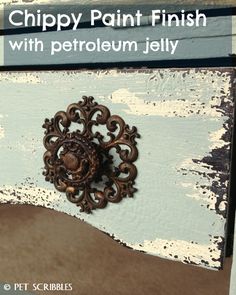 a close up of a piece of furniture with paint on it and the words chippy paint finish with petroleum jelly