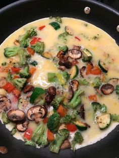 a pan filled with broccoli, mushrooms and cheese