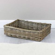 an empty wicker basket sitting on the floor