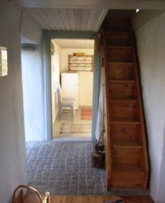 an empty room with stairs leading up to the bedroom