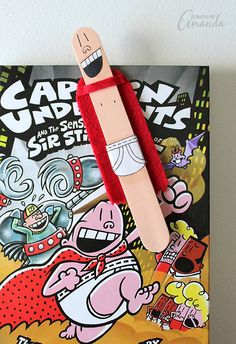 a wooden stick sticking out of the side of a book with cartoon characters on it