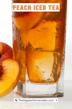 there is a glass of iced tea next to an apple