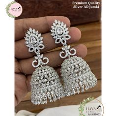 These stunning jhumka earrings are the perfect addition to any bride or bridesmaid's jewelry collection. They are made with high-quality materials and feature a beautiful kundan, beads, and cubic zirconia stones design. The earrings come in three colors: silver, white, and green and purple. The jhumkas are perfect for any wedding or engagement occasion. They are also a great gift for any woman who loves jewelry. Features: Made with high-quality materials Beautiful kundan, beads, and cubic zirconia stones design Available in three colors: silver, white, and green and purple Perfect for any wedding or engagement occasion Great gift for any woman who loves jewelry Materials: Kundan Beads Cubic zirconia stones Silver Care Instructions: To keep your jhumkas looking their best, simply wipe them Luxury Silver Kundan Bridal Earrings, Luxury White Stone Work Jhumkas, Luxury White Jhumkas For Reception, Luxury White Cutdana Jhumkas, Luxury Silver Jhumkas For Anniversary, Luxury Silver Chandbalis For Wedding, Luxury Jhumkas For Anniversary, Luxury Silver Kundan Jhumkas, Luxury Silver Dangle Jhumkas