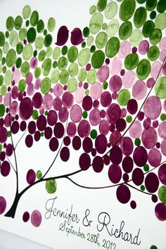 a wedding card with purple, green and pink circles on the tree's branches