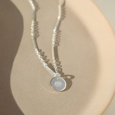 Our Birth Flower Necklace makes a sweet and sentimental gift for any mom or grandma. Crafted with a round disc that is hand-stamped with the flower associated with the month of the child's birth, it is a beautiful and meaningful symbol of the special bond between mother and child. DETAILS14k gold fill or sterling silver14", 16", 18" or 20" lengthsThe charm measures 3/8" Hypoallergenic, Nickel Free and Water Safe Dainty Hand Stamped Round Charm Necklace, Dainty Round Hand-stamped Charm Necklace, Dainty Hand-stamped Round Charm Necklace, Dainty Stamped Charm Necklaces For Mother's Day, Dainty Hand Stamped Round Pendant Necklaces, Dainty Hand Stamped Round Pendant Necklace, Everyday Silver Jewelry With Birth Flower, Mother's Day White Gold Birth Flower Jewelry, White Gold Necklace With Flower Charm Pendant