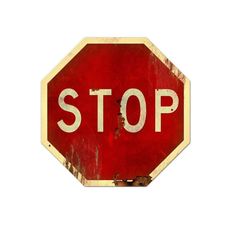 a red stop sign sitting on top of a white wall