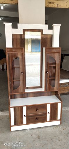 a wooden cabinet with two drawers and a mirror