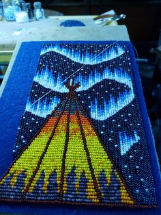 the beaded artwork is being worked on