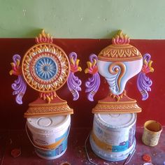 two vases sitting next to each other on top of a table