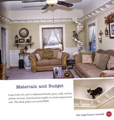 a living room filled with furniture and a cat on the ceiling