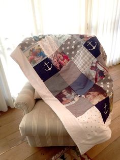 a couch covered in a blanket with pictures on it and an anchor sitting on top of it