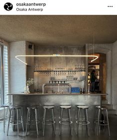 a bar with four stools in front of it