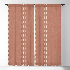 an orange curtain with white dots on it