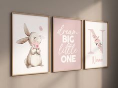 three framed art prints hanging on the wall in a child's room with pink and white decor