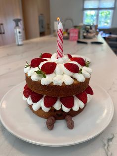 a cake with strawberries and marshmallows on it is sitting on a plate