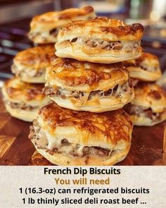 a pile of french dip biscuits sitting on top of a wooden cutting board next to a frying pan