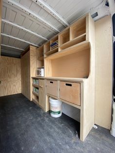 the inside of a truck with some drawers and shelves in it's side wall