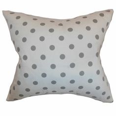 a white pillow with black polka dots on it