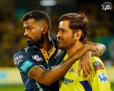 two men hugging each other in front of a crowd at a sporting event, one man has his arm around the other's shoulder