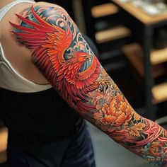 a woman's arm covered in tattoos with flowers and a bird on the left arm