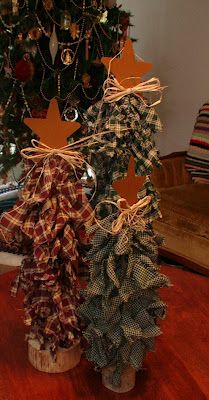 two christmas trees sitting on top of a wooden table