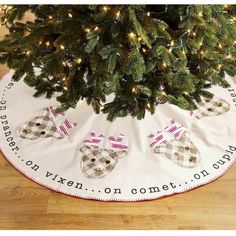 a christmas tree skirt with plaid bows on it