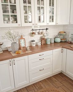 a kitchen with white cabinets and wood counter tops on the instagram page for instagram