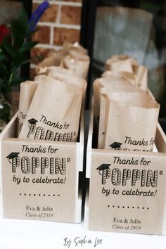 some brown bags with thank you for popin'by to celebrate written on them