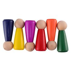 small wooden pegs in different colors on a white background