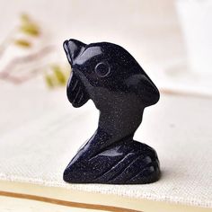 a black figurine sitting on top of a table