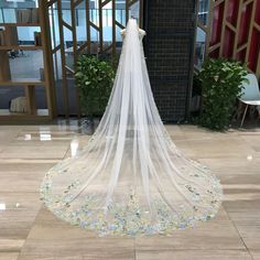 a wedding veil with flowers on the bottom