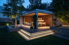 an outdoor living area lit up at night