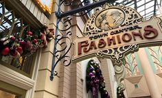 the sign for fashion's in front of a building with christmas decorations on it