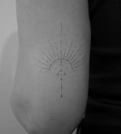 a woman's arm with a sun tattoo on the back of her left arm